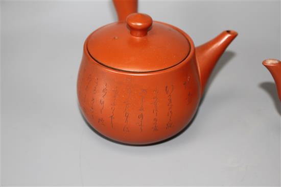 A Chinese Yixing teapot and cover, a redware teapot and cover and a cup